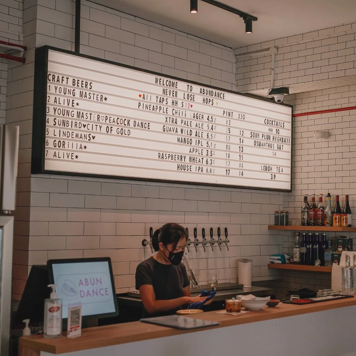 Abundance Redhill — counter and craft-beer taps.